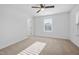 A spacious bedroom with large window, ceiling fan, and carpet floors is freshly painted at 2117 Mckenzie Ridge Lane Ln, Apex, NC 27502