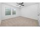 A well lit bedroom featuring a ceiling fan, a window, carpet floors, and neutral paint at 2117 Mckenzie Ridge Lane Ln, Apex, NC 27502
