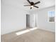 A spacious bedroom with a window, ceiling fan, and freshly cleaned neutral carpet at 2117 Mckenzie Ridge Lane Ln, Apex, NC 27502
