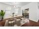Bright dining room featuring hardwood floors, natural light, and access to the screened porch at 2117 Mckenzie Ridge Lane Ln, Apex, NC 27502