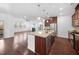 Open floor plan featuring the kitchen island which connects to the living room with fireplace at 2117 Mckenzie Ridge Lane Ln, Apex, NC 27502