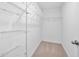 A walk-in closet featuring carpet floors, white walls, and metal shelving racks along the perimeter at 2117 Mckenzie Ridge Lane Ln, Apex, NC 27502