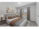 Bright bedroom features a neutral color palette, large window, and stylish décor, creating a serene and inviting space at 236 Shingle Oak Rd, Wake Forest, NC 27587