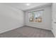 Bright bedroom with neutral walls, large window and carpet, creating an inviting space for rest and relaxation at 236 Shingle Oak Rd, Wake Forest, NC 27587