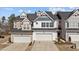 Charming townhome with a two-car garage, a beautifully designed roofline, and manicured landscaping at 236 Shingle Oak Rd, Wake Forest, NC 27587
