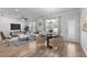 Bright living room with hardwood floors, modern furnishings, and large windows at 236 Shingle Oak Rd, Wake Forest, NC 27587