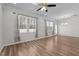 Bright, open living room with hardwood floors, large windows, and modern ceiling fan at 236 Shingle Oak Rd, Wake Forest, NC 27587