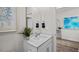 Well-lit half-bath with a white countertop vanity, a leafy plant, and a decorative art piece at 24 Saddle Mare St, Clayton, NC 27520