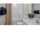 Clean bathroom with a shower-tub combo, a light countertop, and a decorative leafy plant at 24 Saddle Mare St, Clayton, NC 27520