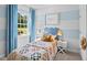 bedroom featuring pastel blue colors, a matching bed set, and a sunlit window at 24 Saddle Mare St, Clayton, NC 27520
