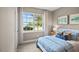 Cozy bedroom featuring a patterned bedspread, decorative pillows, and a view of the outdoors at 24 Saddle Mare St, Clayton, NC 27520