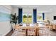 Bright dining area with large windows, a wooden table set, and tasteful decor at 24 Saddle Mare St, Clayton, NC 27520