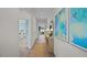 Bright hallway with decorative art and a jute rug that leads into a bedroom and living area at 24 Saddle Mare St, Clayton, NC 27520
