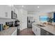 Modern kitchen with stainless steel appliances, granite countertops, and a kitchen island sink at 24 Saddle Mare St, Clayton, NC 27520