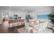 Spacious open concept featuring kitchen island with bar stools and dining table, perfect for entertaining at 24 Saddle Mare St, Clayton, NC 27520
