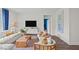 Inviting living room with comfortable seating, stylish decor, and a large TV for entertainment at 24 Saddle Mare St, Clayton, NC 27520