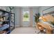 Well-lit office space with a decorative desk, shelving, and a view of the outdoors at 24 Saddle Mare St, Clayton, NC 27520
