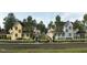 Charming new homes line a street, featuring colorful exteriors and inviting front yards at 2656 Welham Aly, Raleigh, NC 27608