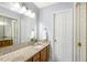 Bathroom featuring a granite countertop, ample lighting, and a large mirror at 2820 Bedfordshire Ct, Raleigh, NC 27604
