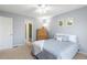 Comfortable bedroom with queen bed, ceiling fan, and light gray walls at 2820 Bedfordshire Ct, Raleigh, NC 27604