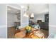 Dining area open to living room showcasing table setting and modern lighting fixture at 2820 Bedfordshire Ct, Raleigh, NC 27604