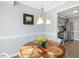 Bright dining area adjacent to the kitchen with modern light fixture and table setting at 2820 Bedfordshire Ct, Raleigh, NC 27604