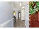 View from doorway, highlighting the foyer, wood floors, stainless steel refrigerator and grey sofa at 2820 Bedfordshire Ct, Raleigh, NC 27604