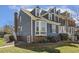 Charming townhome with blue siding, brick accents, manicured landscaping, and dormer windows at 2820 Bedfordshire Ct, Raleigh, NC 27604