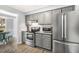 Modern kitchen with stainless steel appliances, granite counters, and access to the dining area at 2820 Bedfordshire Ct, Raleigh, NC 27604