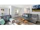 Bright living room featuring gray sofas, contemporary decor, and modern furnishings at 2820 Bedfordshire Ct, Raleigh, NC 27604