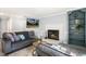 Cozy living room with fireplace, gray couches, and a wall-mounted television at 2820 Bedfordshire Ct, Raleigh, NC 27604