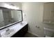 Bathroom with double sinks, storage cabinet, and a large mirror at 308 Trimble Ave, Cary, NC 27511