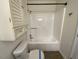 Clean bathroom with a tub and shower combo, storage cabinet, and tile flooring at 308 Trimble Ave, Cary, NC 27511