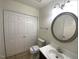 Bathroom featuring a sink, toilet, closet, and a large mirror at 308 Trimble Ave, Cary, NC 27511