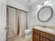 Cozy bathroom featuring a shower with curtain, toilet, and vanity with a round mirror and lighting fixture at 308 Trimble Ave, Cary, NC 27511