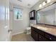 Bathroom with a shower, a vanity with countertop, and a window offering natural light at 308 Trimble Ave, Cary, NC 27511