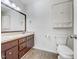 Bathroom with double sink vanity, tile floor, toilet and wall storage cabinet at 308 Trimble Ave, Cary, NC 27511
