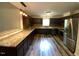 Well-equipped kitchen with dark cabinetry, granite counters, stainless appliances, and wood-look floors at 308 Trimble Ave, Cary, NC 27511