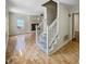 Living room with a cozy fireplace, hardwood floors, a staircase and plenty of natural light at 308 Trimble Ave, Cary, NC 27511