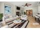 Bright living room featuring a fireplace, hardwood floors, and neutral decor, virtually staged for inspiration at 308 Trimble Ave, Cary, NC 27511