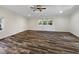 Spacious living room with wood-look floors, a ceiling fan, recessed lighting, and multiple windows for natural light at 308 Trimble Ave, Cary, NC 27511
