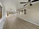 Enclosed porch with wood flooring, ceiling fan, and multiple windows offering an outdoor view at 308 Trimble Ave, Cary, NC 27511