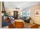 Bright living room with hardwood floors, a ceiling fan, and a view of the backyard at 347 Carlton Dr, Chapel Hill, NC 27516