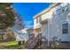 Exterior of home with a well-maintained backyard, stairs up to a back deck, and a view of a well-manicured lawn at 4120 Standing Rock Way, Raleigh, NC 27604