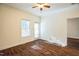 Cozy bedroom featuring hardwood floors, natural light, ceiling fan, and a doorway to the backyard at 4120 Standing Rock Way, Raleigh, NC 27604