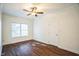 Bedroom with dark wood floors, a ceiling fan, and a window for natural light at 4120 Standing Rock Way, Raleigh, NC 27604