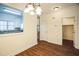 Inviting dining area with hardwood floors, stylish chandelier, view to kitchen, and access to a large closet at 4120 Standing Rock Way, Raleigh, NC 27604
