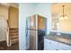 Kitchen features a stainless steel refrigerator and granite countertops at 4120 Standing Rock Way, Raleigh, NC 27604