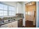 A bright kitchen features white cabinets, granite countertops, and stainless steel appliances at 4120 Standing Rock Way, Raleigh, NC 27604