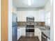 Well-equipped kitchen featuring stainless steel appliances, granite countertops, and ample cabinet space at 4120 Standing Rock Way, Raleigh, NC 27604